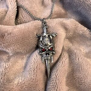 SPENCERS Chunky Silver Skull and Dagger Gothic Necklace with Red Crystals